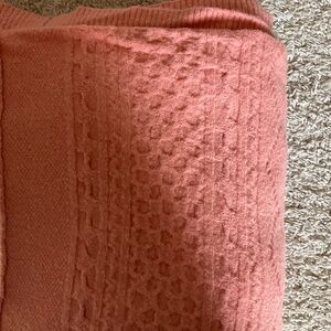 J.CREW KNIT THROW BLANKET. SIZE: 50X70". COLOR: PEACHY CORAL.